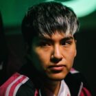 StingeR, a Dota 2 player, stares forward at his desk at The International.