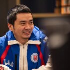 Xiao8 smiling while his team prepares to compete at TI12.