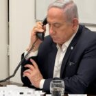 In this handout photo, released early Sunday local time, Israeli Prime Minister Benjamin Netanyahu talks on the phone with US President Joe Biden. Portions of this photo have been blurred by the source. - Israeli Prime Minister's Office