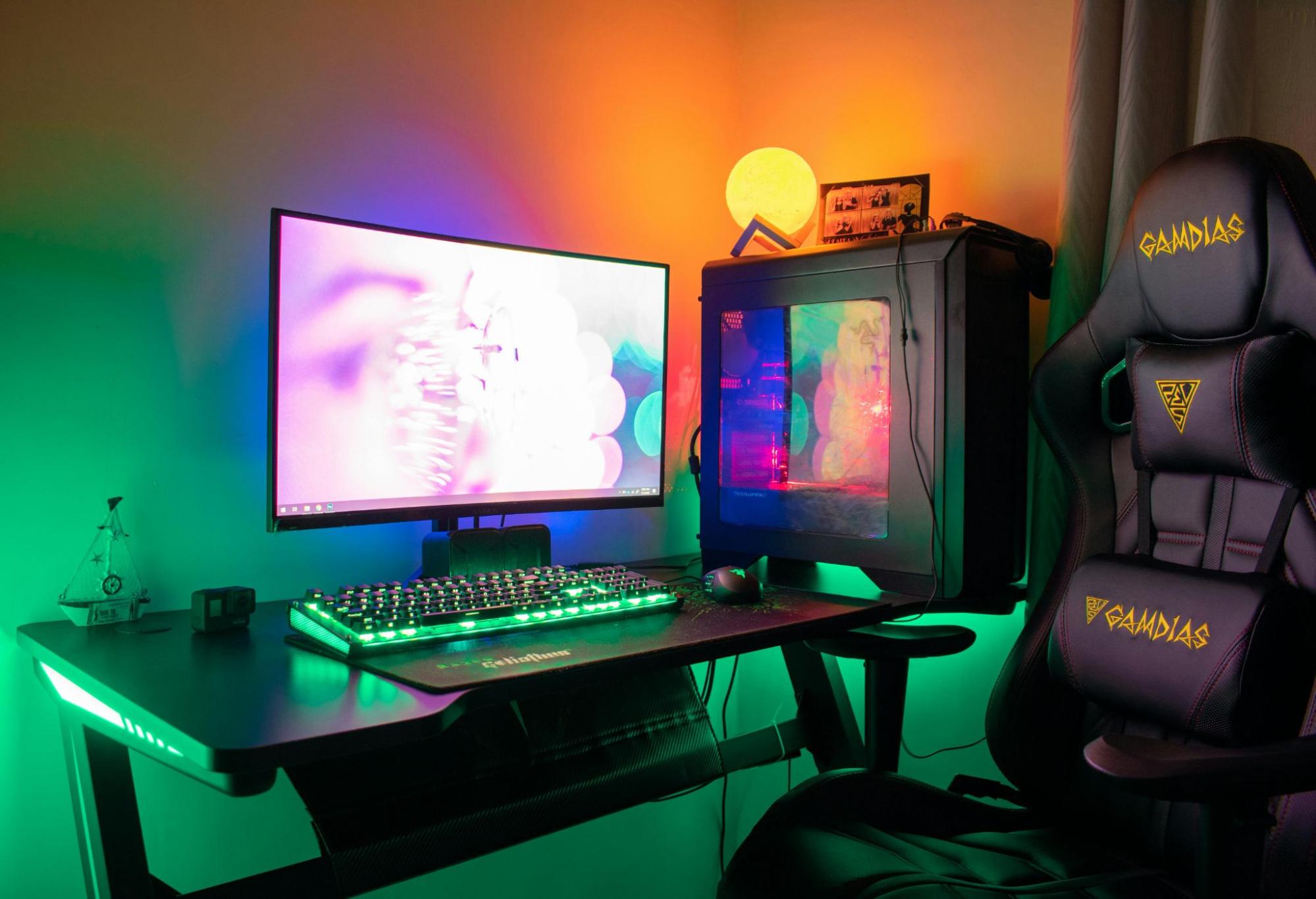 A gaming setup with a chair, monitor, and PC.