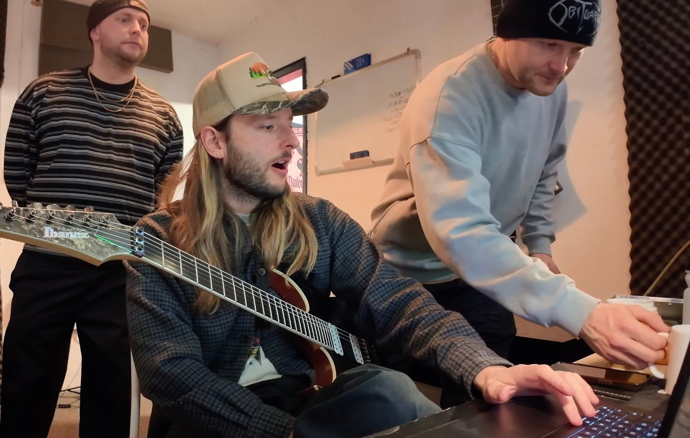 Malevolence band members in the studio tracking a song for World of Warcraft: Midnight, with instruments and recording equipment visible